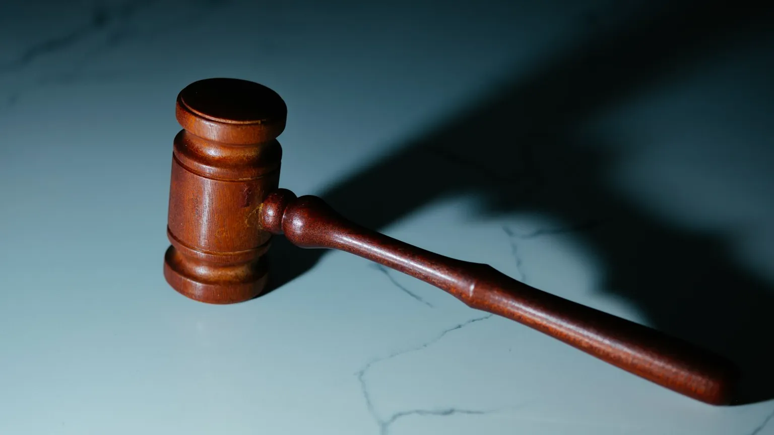 A wooden judge's gavel representing cannabis law and regulation